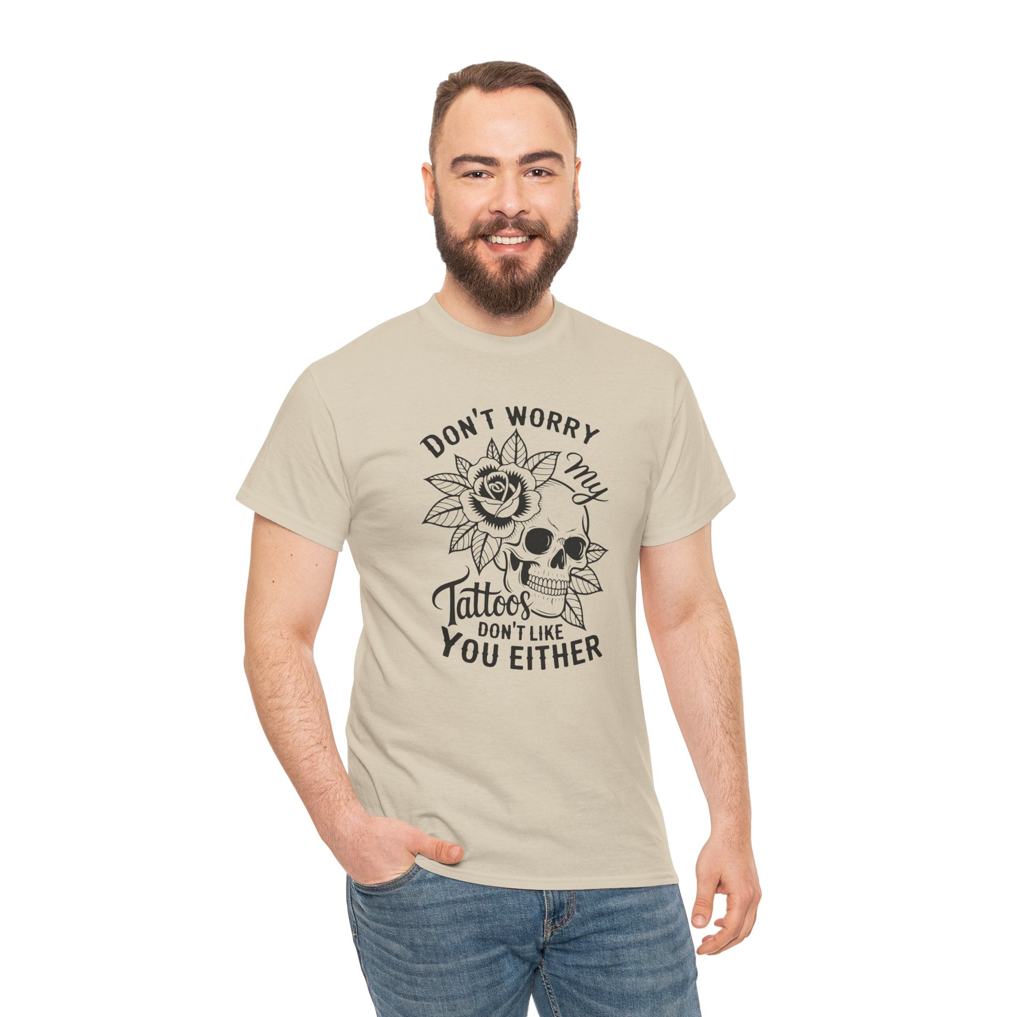 Man wearing a beige t-shirt with a skull and roses design and text on a white background