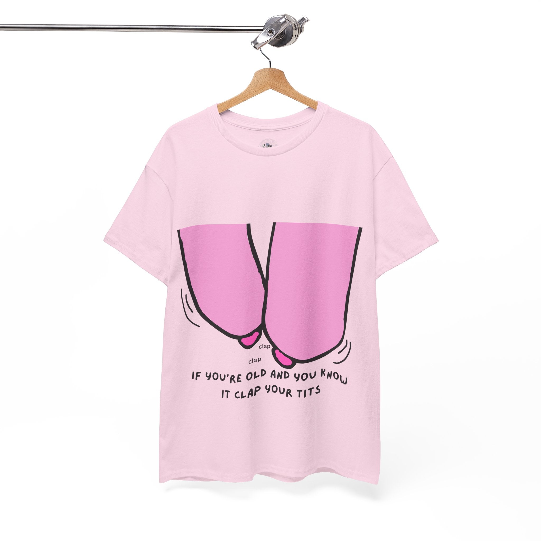 Pink t-shirt with graphic design and text on a hanger against a white background