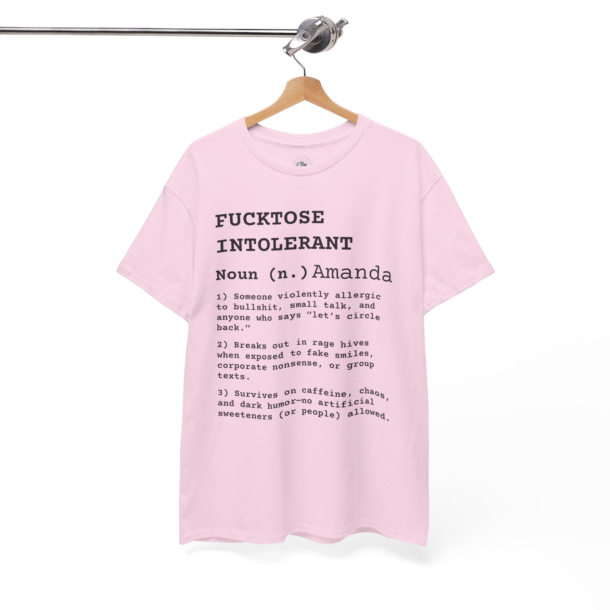Pink t-shirt with text on a hanger against a white background