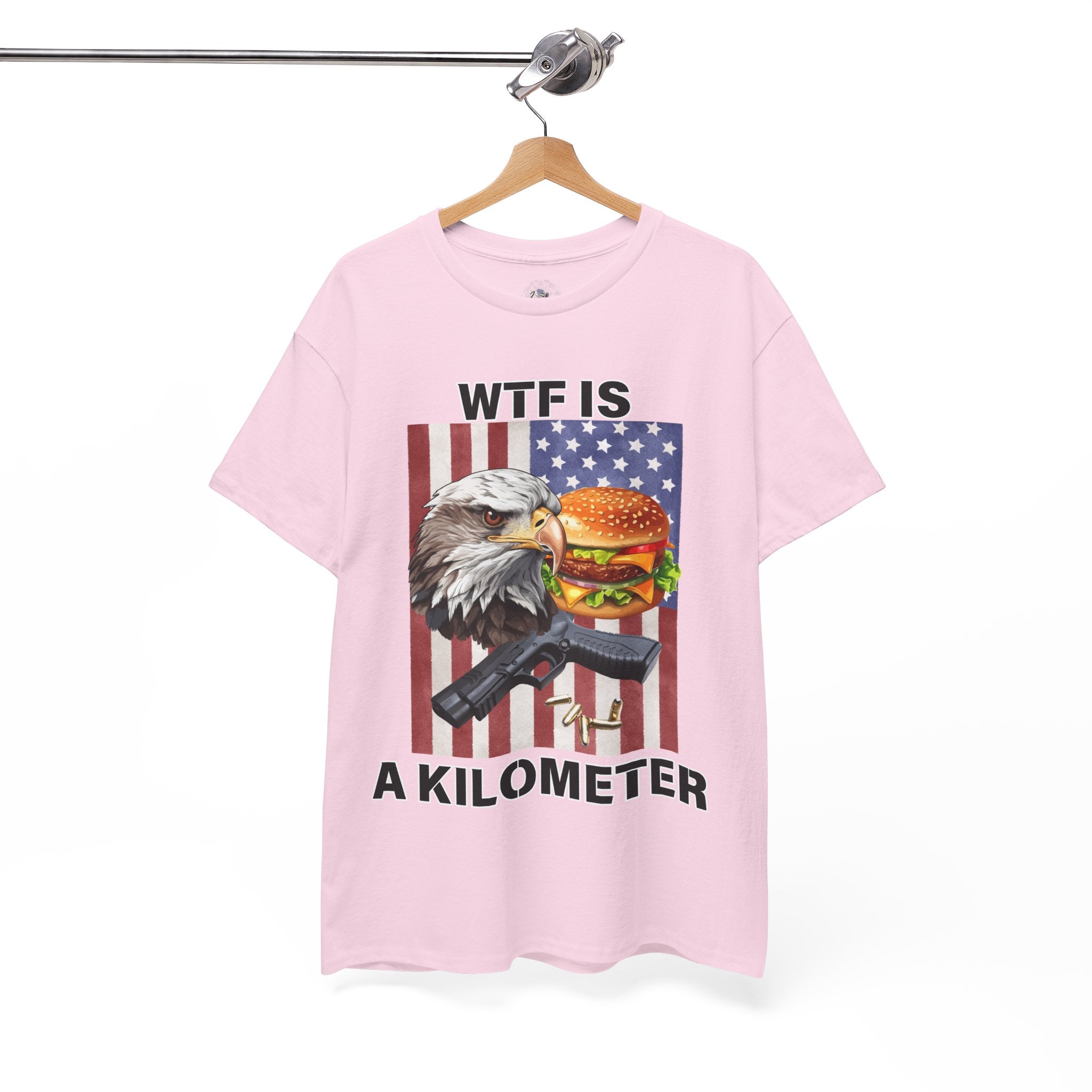 Pink t-shirt with graphic design featuring an eagle, burger, and American flag on a hanger.