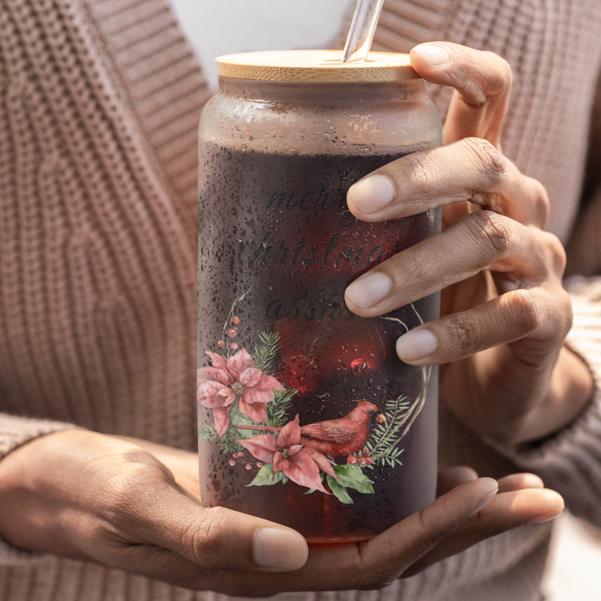 Person holding a tumbler with an offensive joke christmas design