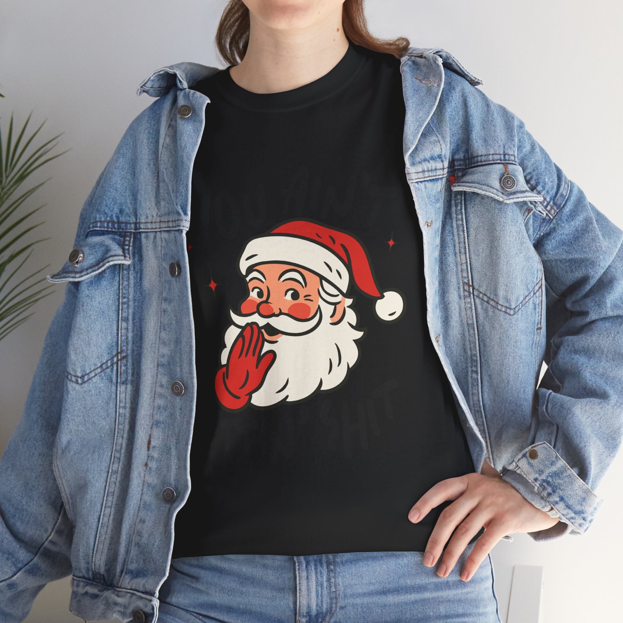 Person wearing a black t-shirt with a Santa Claus graphic and a denim jacket.
