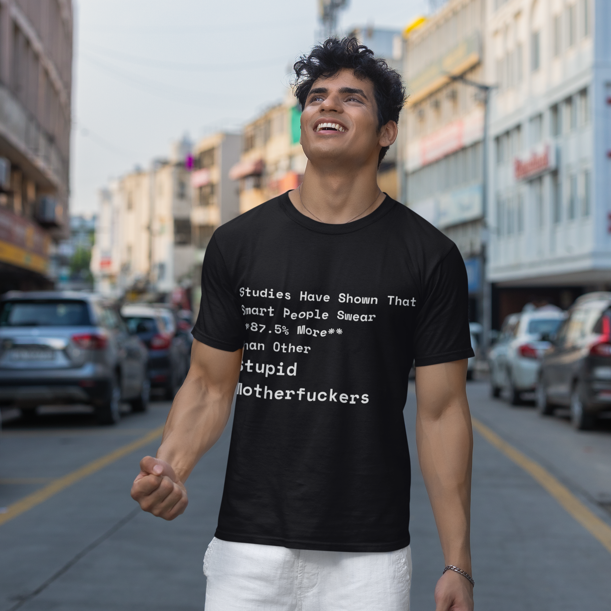 Man wearing a black t-shirt with text on a city street