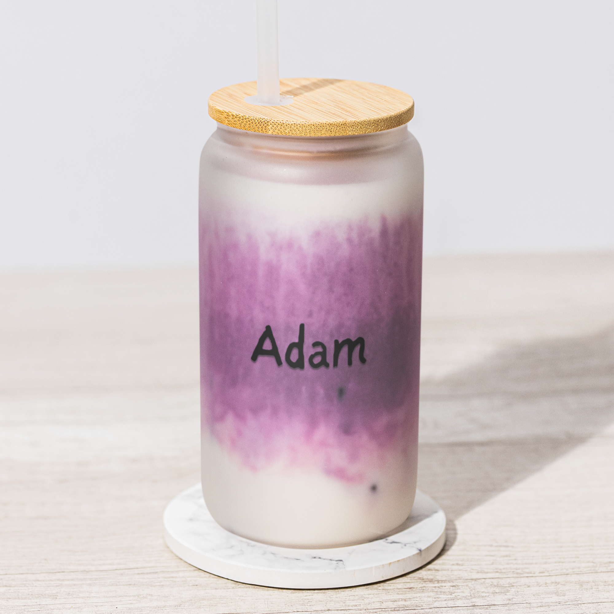 glass mug with a wooden lid on a white surface, featuring the custom name 'Adam'.