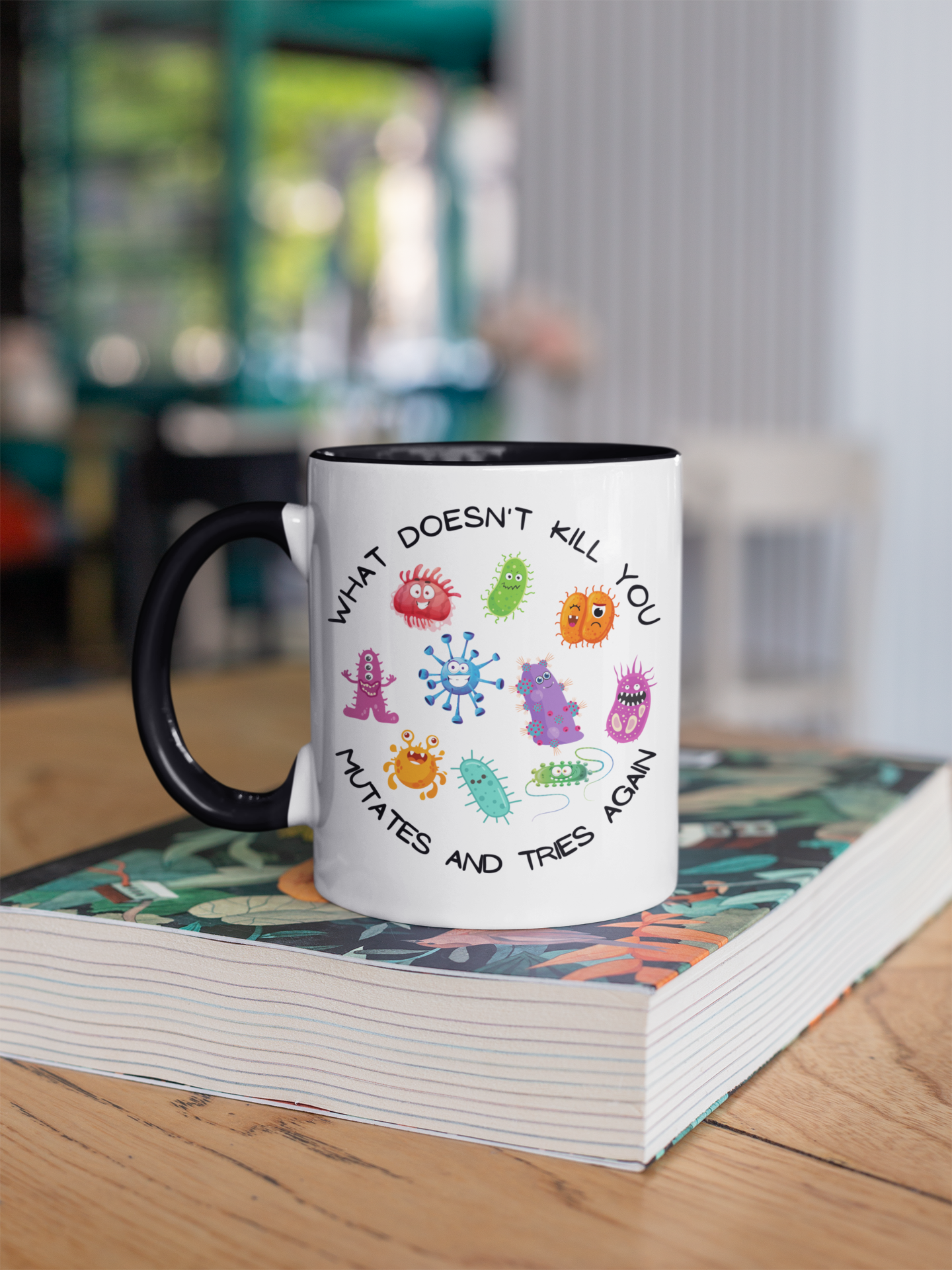 Mug with colorful designs and text on a books