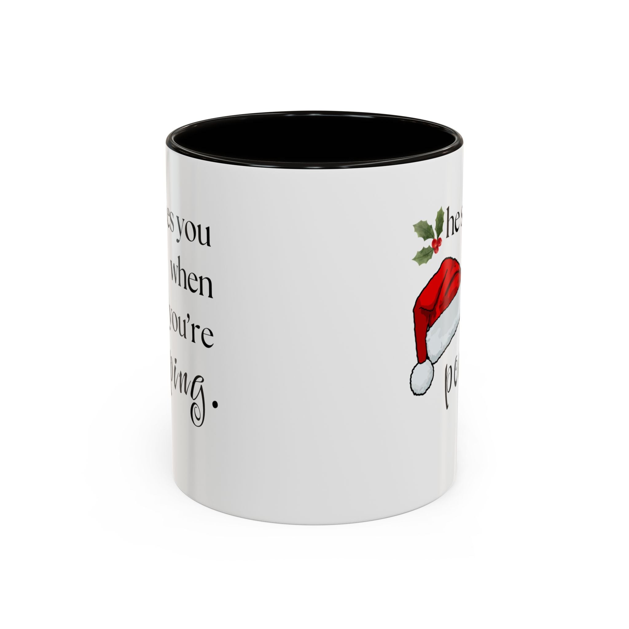 White mug with black interior, Christmas-themed text, and Santa hat graphic on a white background