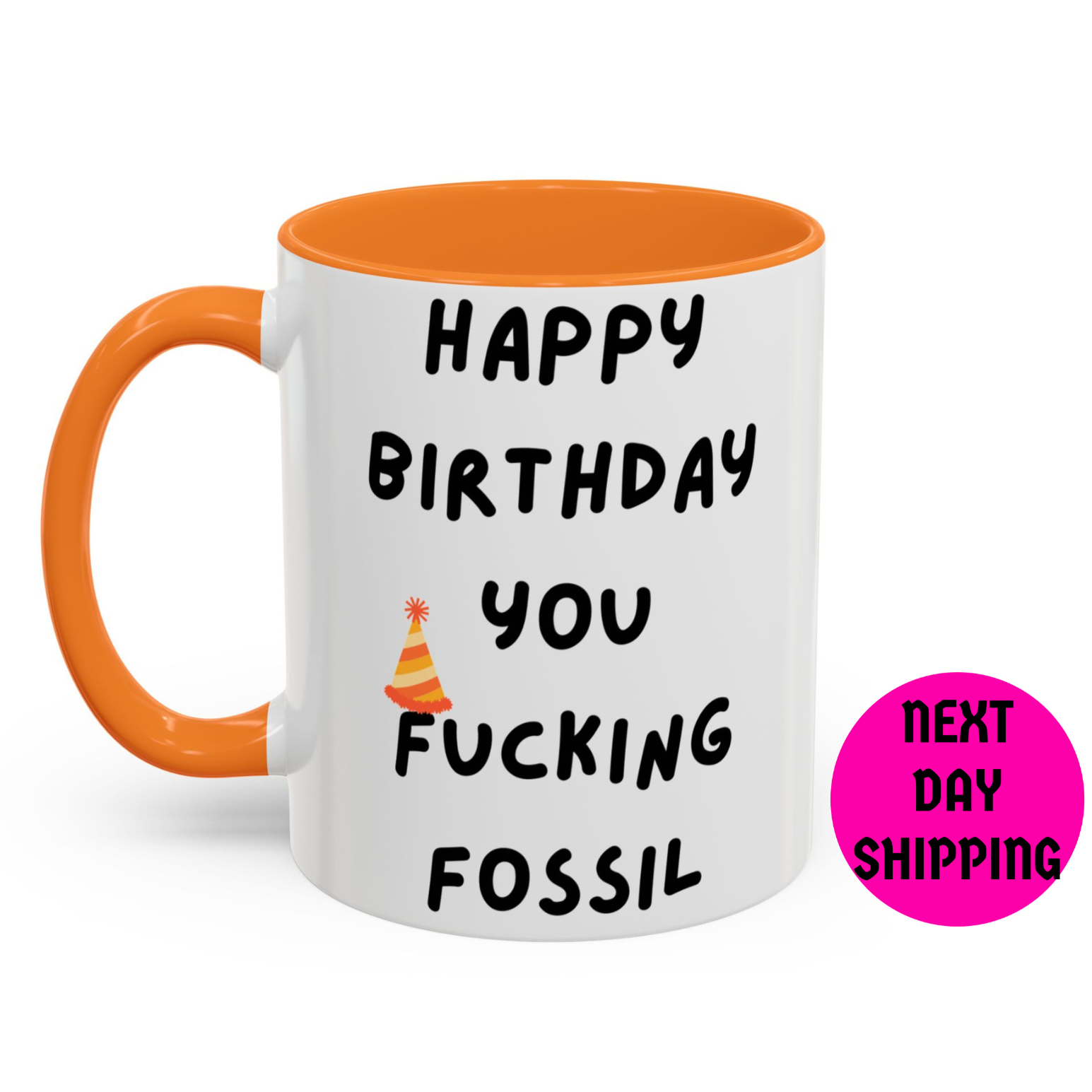 Mug with text 'Happy Birthday you fucking fossil' and orange handle on a white background