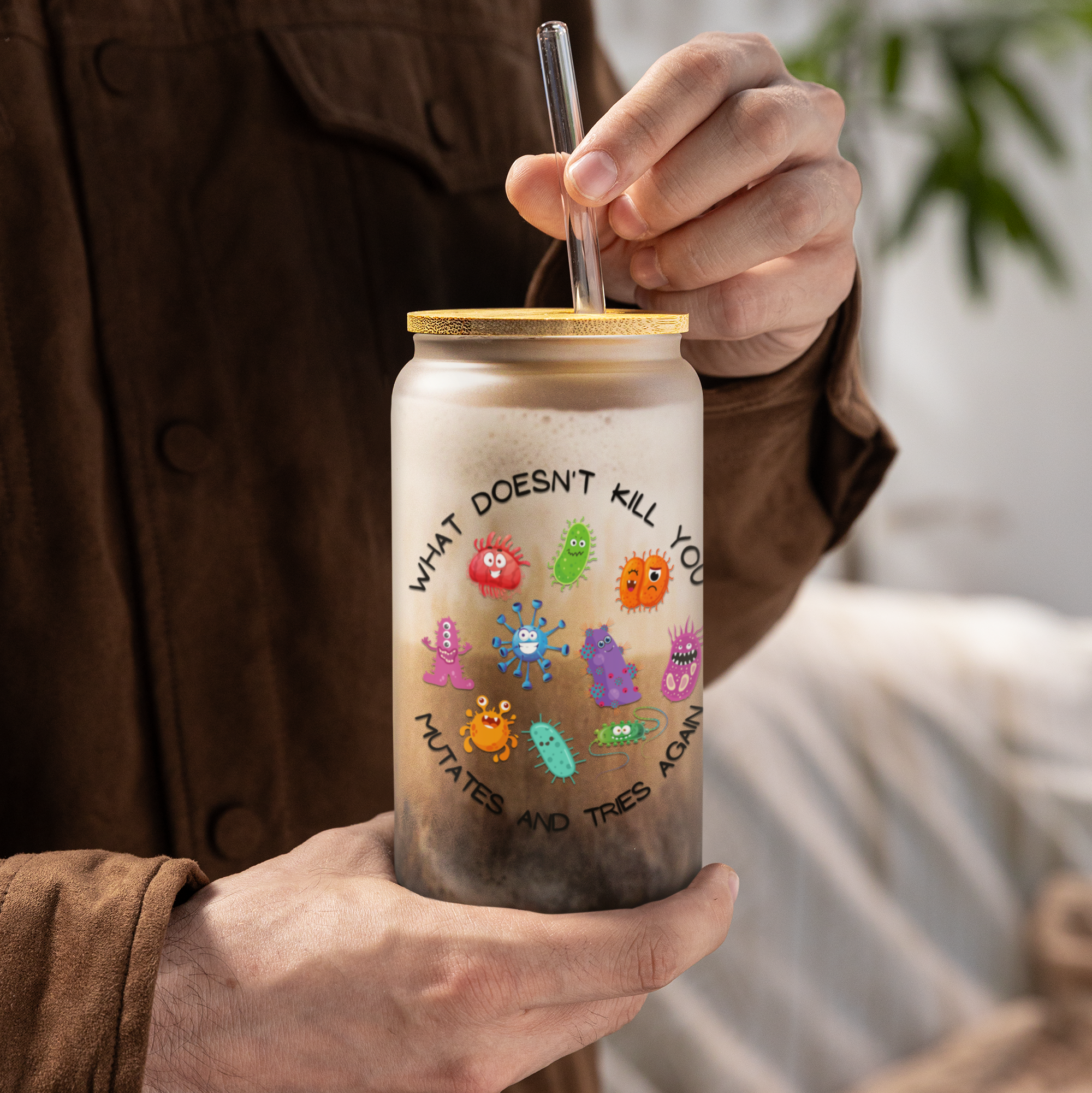 Person holding a glass jar with a straw, featuring colorful cartoon characters and text.