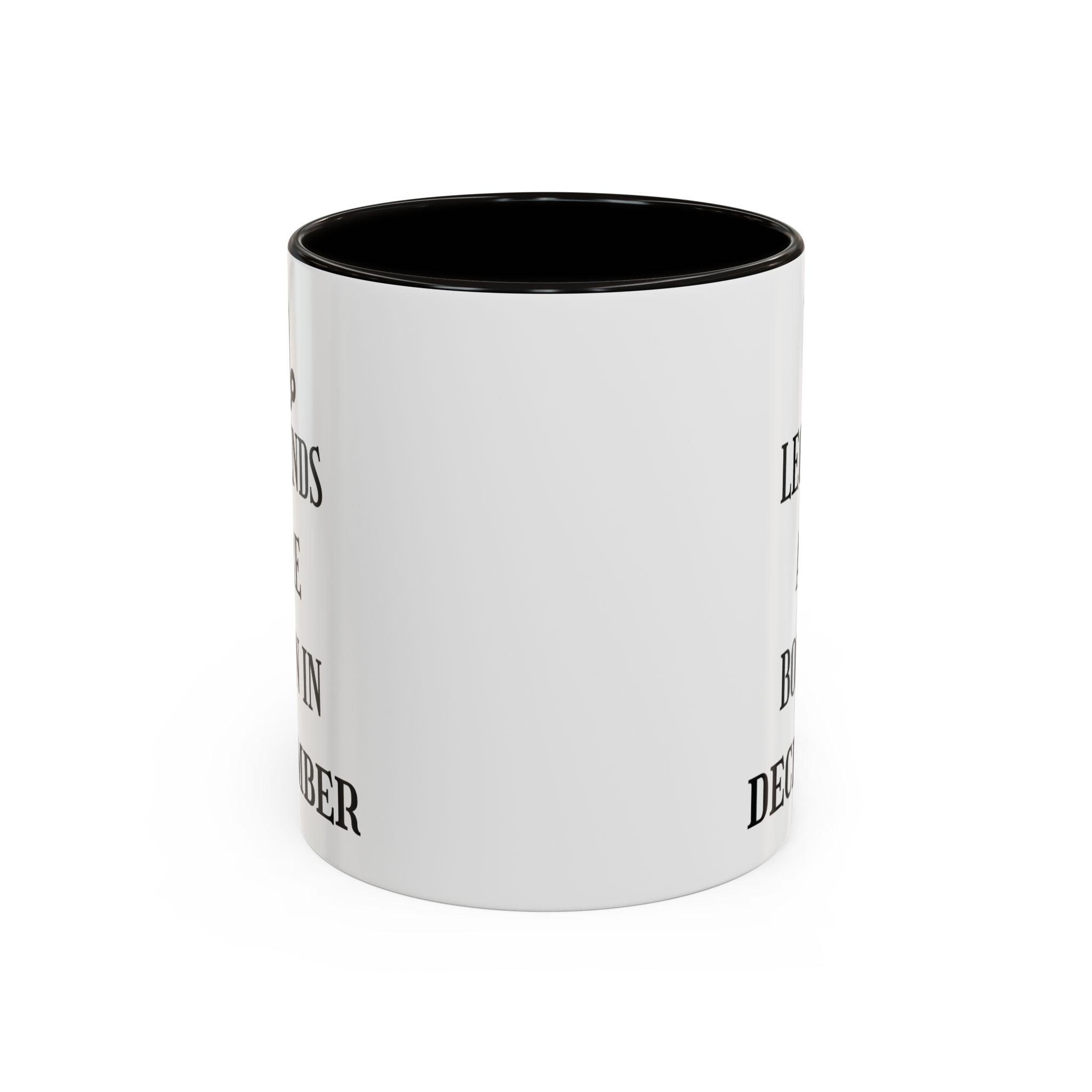 White mug with black interior and Legends Are Born in December text on a white background