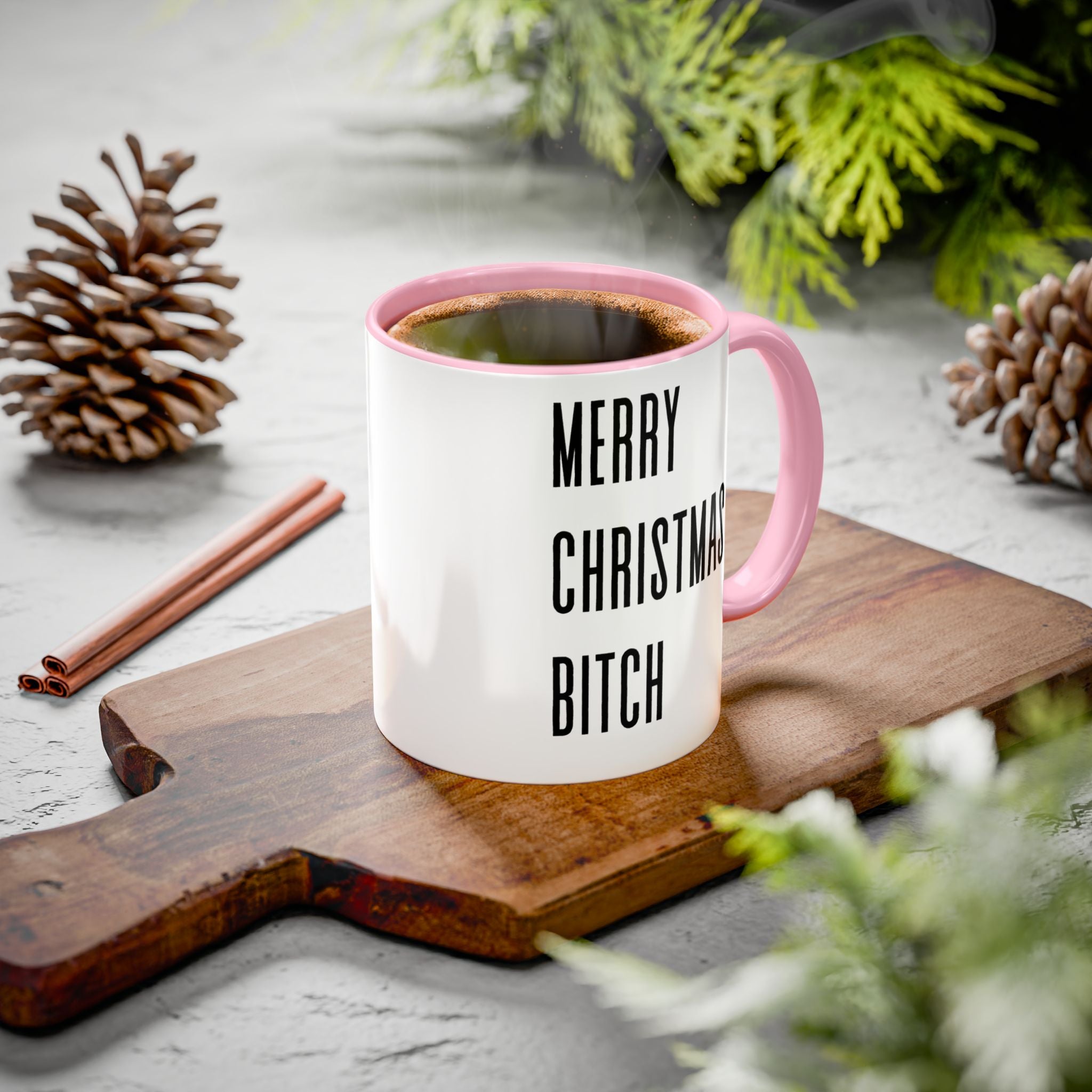 Mug with 'Merry Christmas Bitch' text on a wooden board with festive decorations.