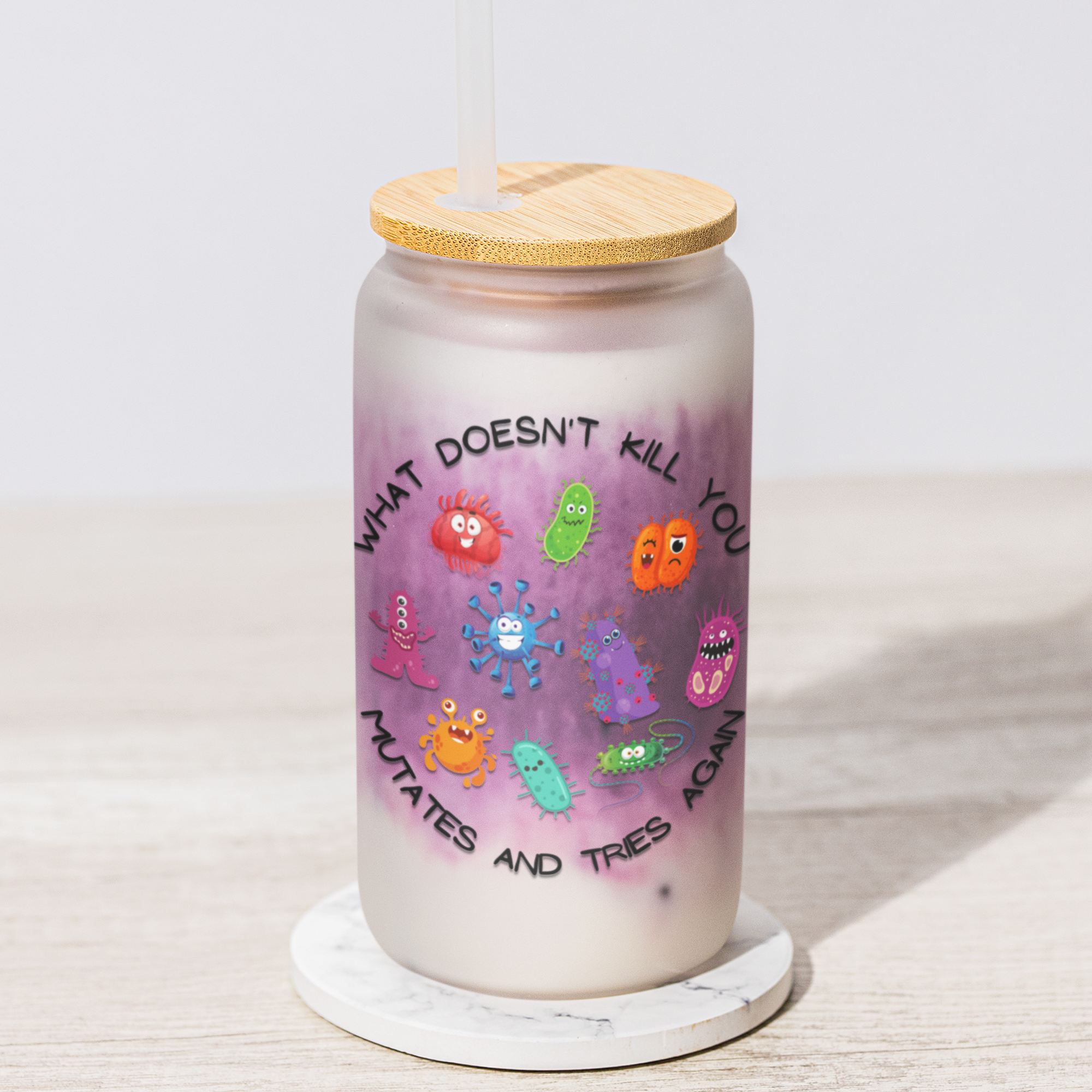 Glass 16oz tumbler with colorful illustrations and text on a white surface