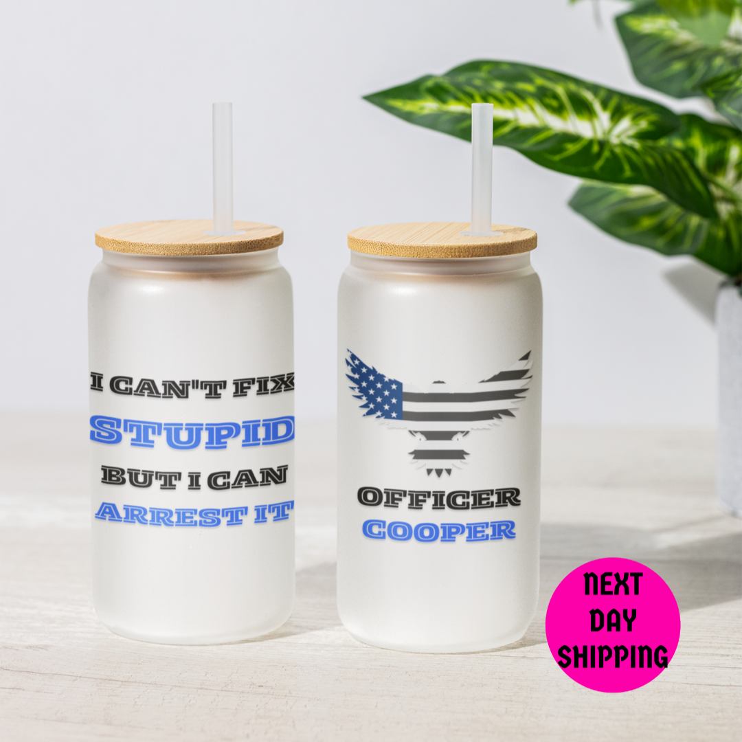 Two tumblers with wooden lids and funny text on a light surface with a plant in the background and next day shipping sign