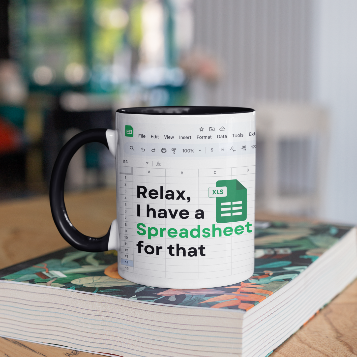 Mug with spreadsheet design and text 'Relax, I have a Spreadsheet for that' on a book