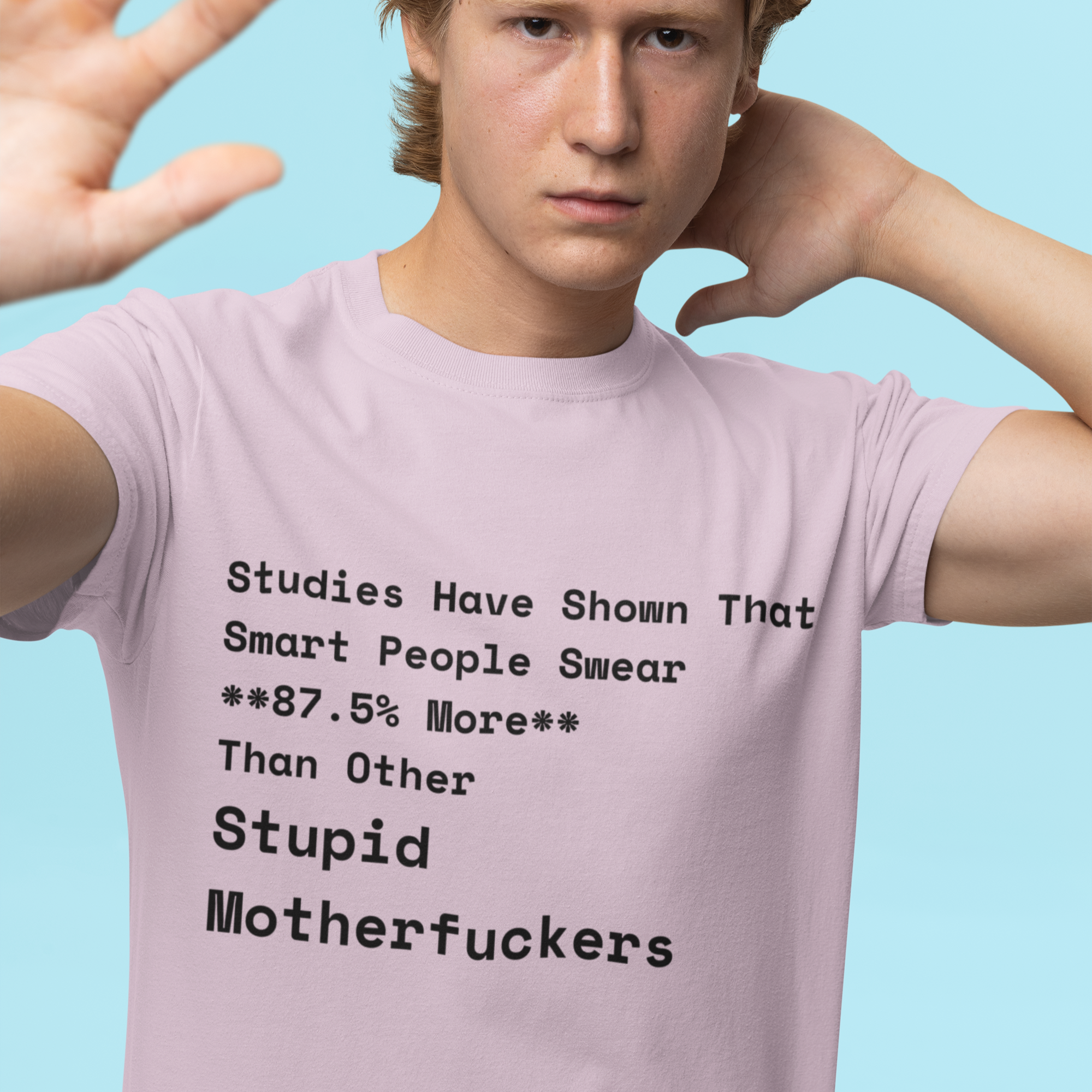 Person wearing a pink t-shirt with text on a blue background